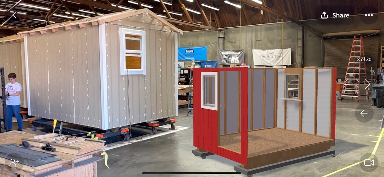 3D model of a tiny home product being viewed in augmented reality next to a real tiny home product using JigSpace
