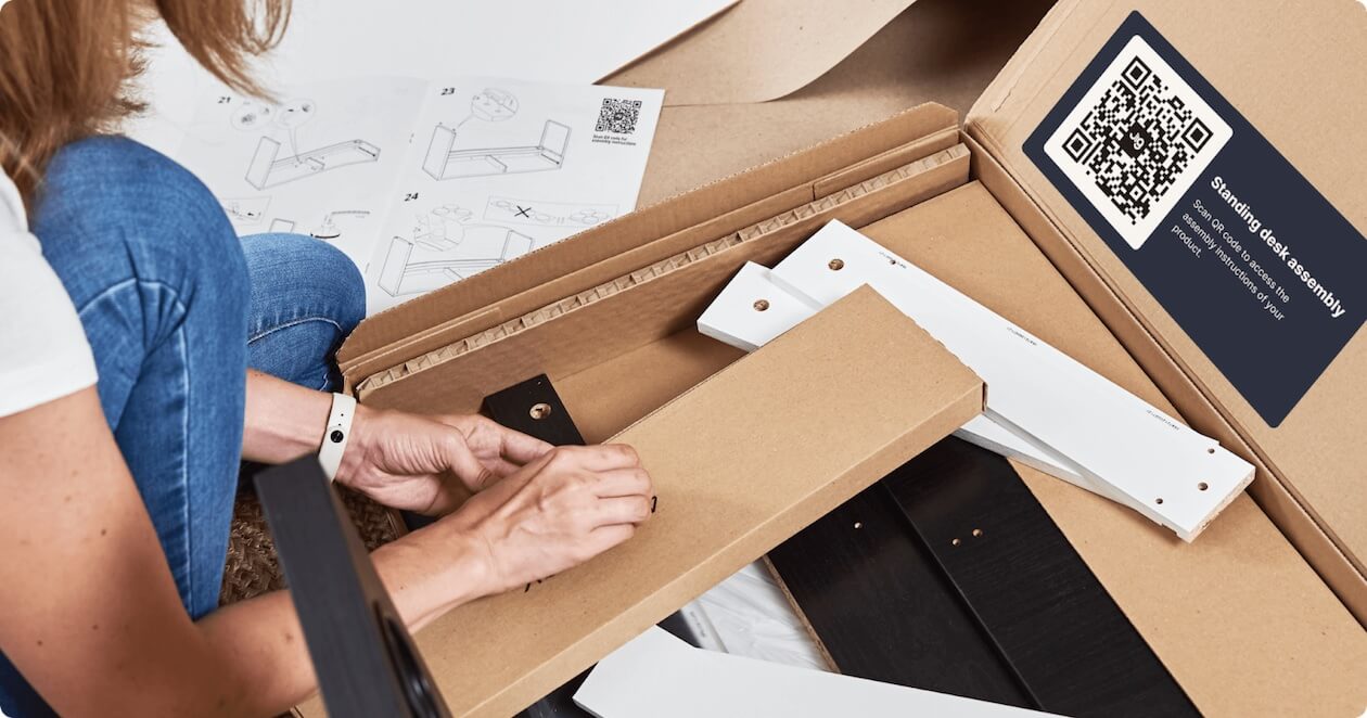 A flat pack piece of furniture with assembly instructions provided with a Jig QR code