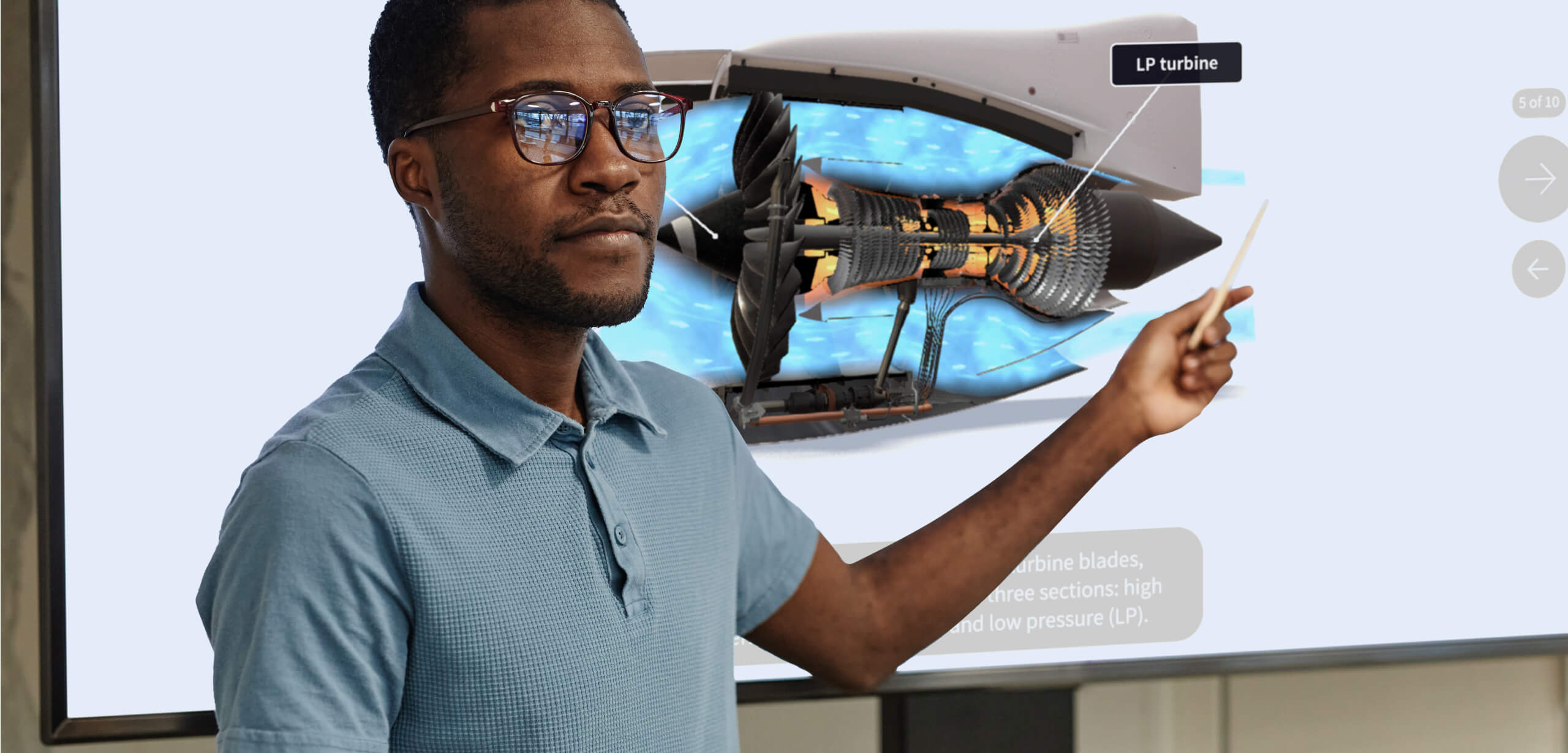 A teacher pointing at augmented reality 3d visualization of a jet turbine in a university classroom